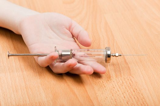 Syringe in addict hand