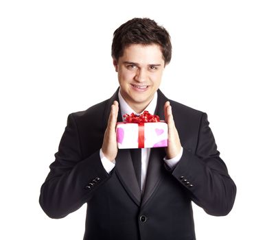A man holding present box in formal black tux