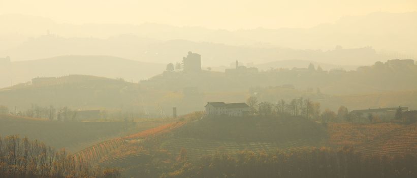 Panoramic view on hills covered by morning haze in Piedmont, Northern Italy.