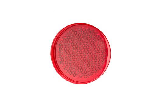 Red round reflector on white.
