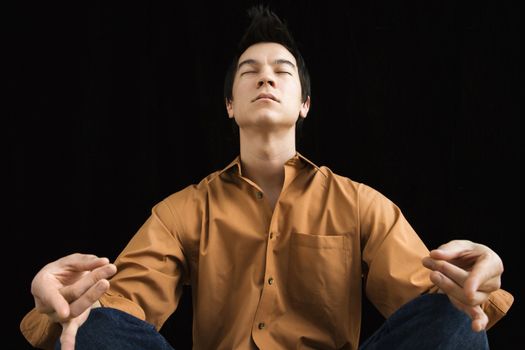 Man sitting meditating.