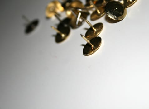 Thumbtacks with the focus on the the points of the front tacks.