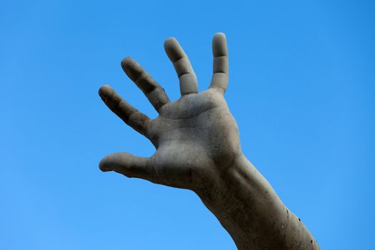 the stony hand against the background of the sky.