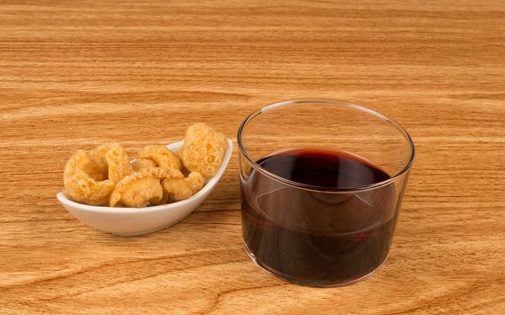 Red wine and chicharrones, a traditional appetizer