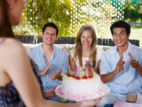Friends with cake at birthday party
