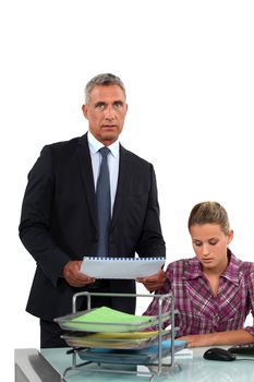 Businessman giving his overworked assistant more work