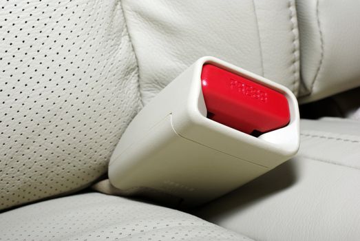 Close up photo of seat belt press button. Interior of modern jap