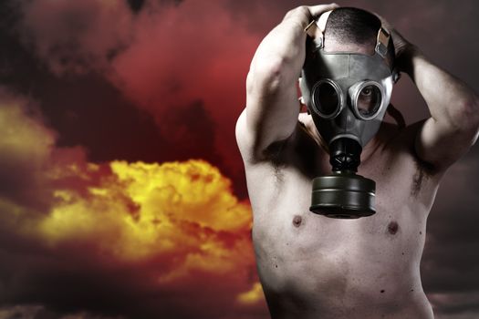Portrait of a man in a polluted ambience with gas mask