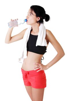 Young fit woman drinking mineral water