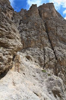 climbing way with metal ladder and steel ropes in Italian Dolomites