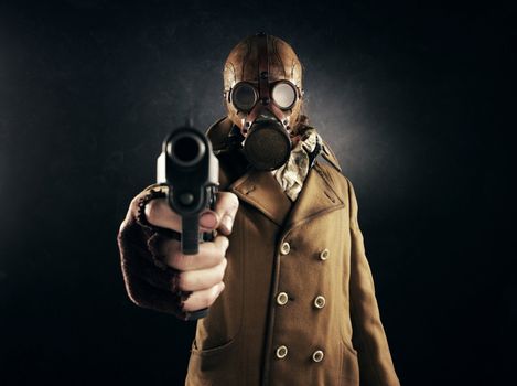 grunge portrait man in gas mask pointing a gun