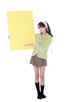 Girl in green sweater and glasses gesturing to a blank yellow si