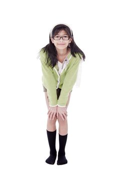 Girl in green sweater and glasses bending forward, hand on knees
