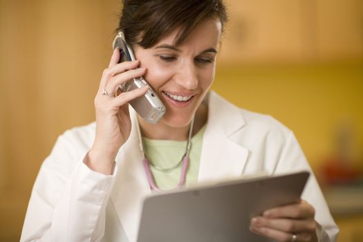 Doctor on phone reading medical records
