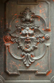 Monstrous face carved in a door