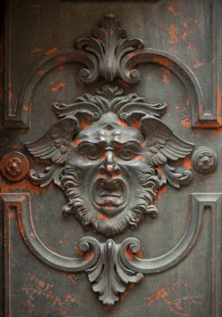 Monstrous face carved in a door