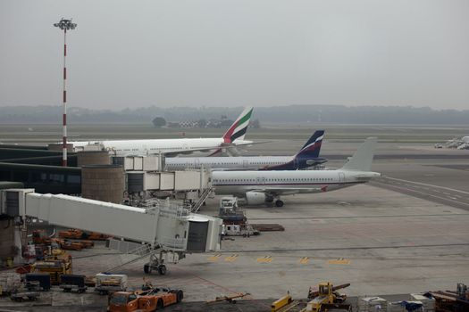 Three aeroplanes parked at airport