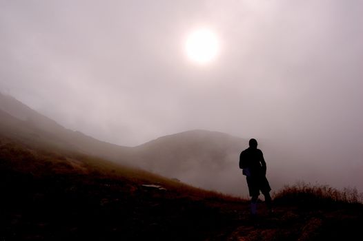 Man and foggy mountains