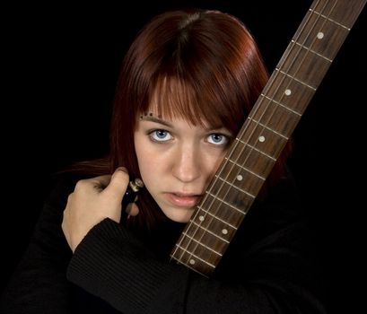 Redhead girl holding her guitar