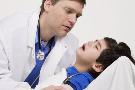 Male doctor comforting disabled  toddler patient. Child is five years old