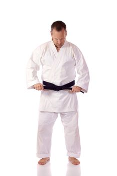 Karateka fastening his belt