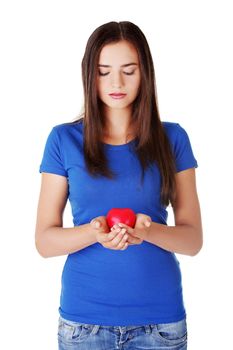 Teen girl holding red heart. Isolated.