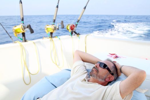 Sailor senior fisherman relax on boat fishing sea