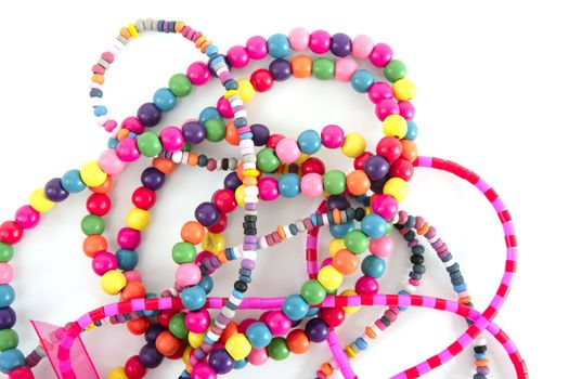 Colorful wood necklaces mess over white