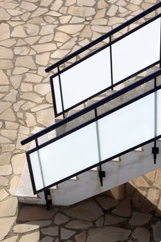 glass banisters stairway with masonry floor