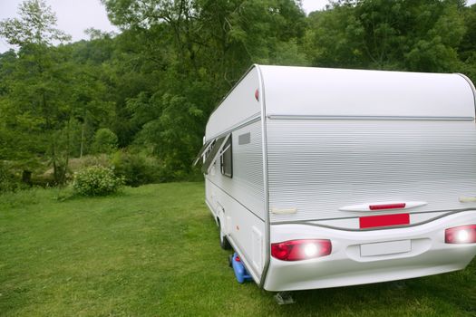 Caravan van in the green meadow camping