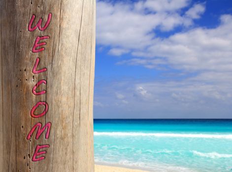 Caribbean beach spell welcome written in pole