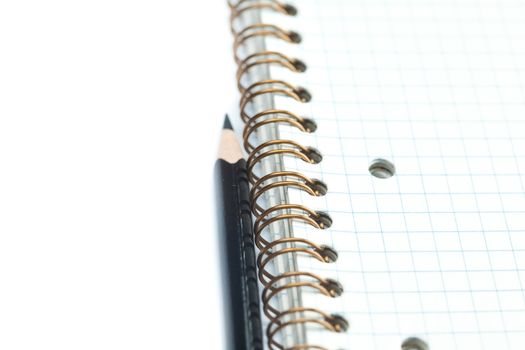 plaid notebook with a spiral  and pencil