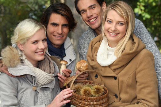 group of young people with a basket of chestnuts and mushrooms
