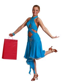Young happy blonde woman in a fancy dress with shopping bag jumping against a white background.