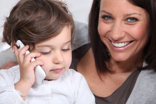 Mother and daughter with mobile telephone