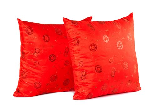 two red decorative pillows with pattern