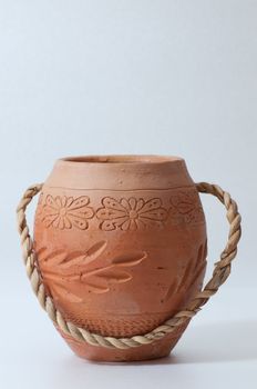 round shaped jar made from clay isolated