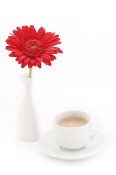 Flower in vase near caup of coffee