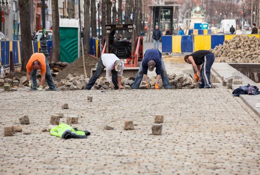 Workmen rebuild cobbled street in Brussels