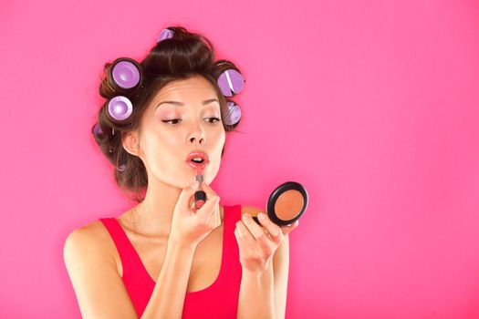 Makeup woman putting lipstick
