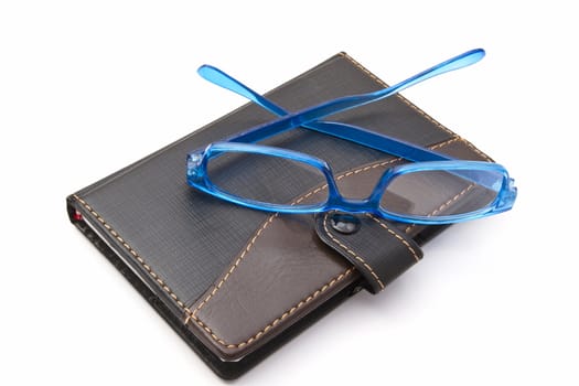 notebook and glasses isolated on white background 