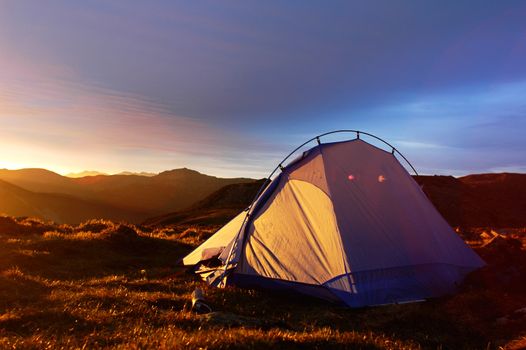 Landscape of camping tent on the top of mountains in the morning sunlight