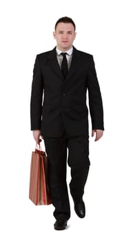 Young businessman with shopping bag walking against a white background.