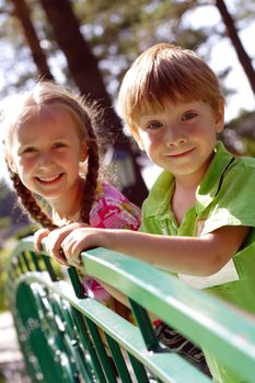 boy and girl standing on the bridge and smiling, outdoors