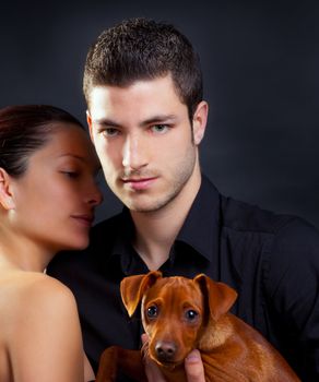 Couple in love with brown little pet puppy dog mini pinscher