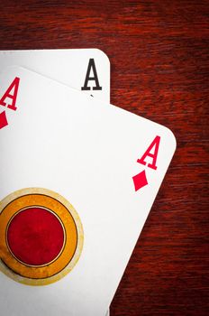 A pair of aces on wooden background