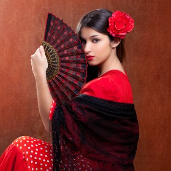 Gipsy flamenco dancer Spain girl with red rose and spanish hand fan