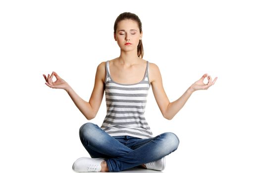 Student girl over white background meditating in lotus pose