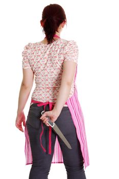 Housewife in pink apron with knife behind her back .
