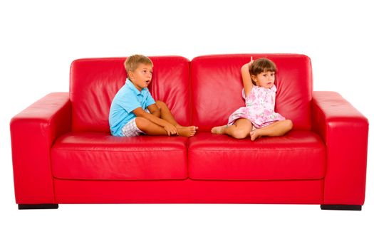 brother and sister on red sofa